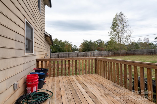 wooden deck with a lawn