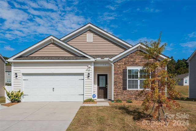 view of front facade featuring a front lawn and a garage