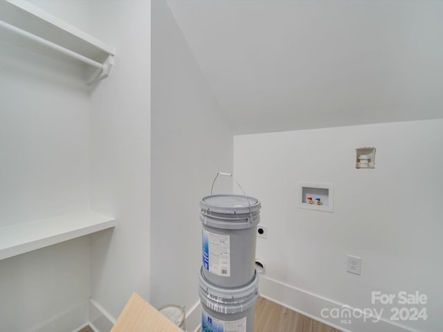 laundry room featuring hookup for an electric dryer, hookup for a washing machine, and hardwood / wood-style flooring