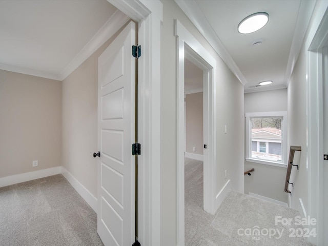 hallway featuring light carpet and ornamental molding