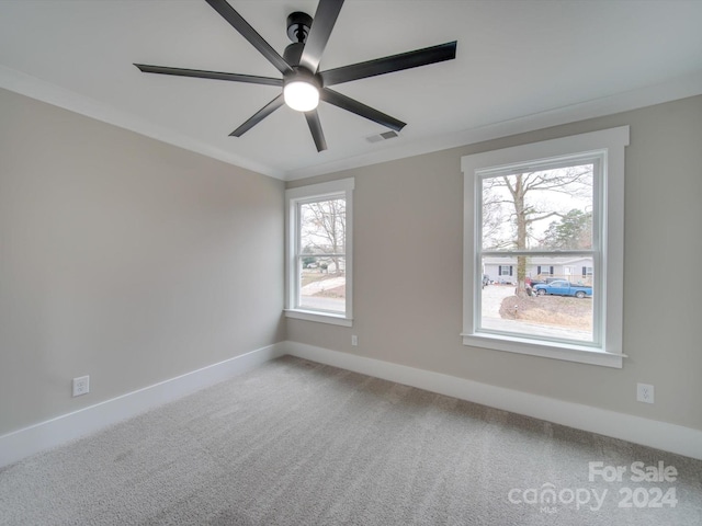 empty room with ceiling fan, ornamental molding, carpet floors, and a wealth of natural light