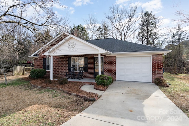 ranch-style home with a porch and a garage