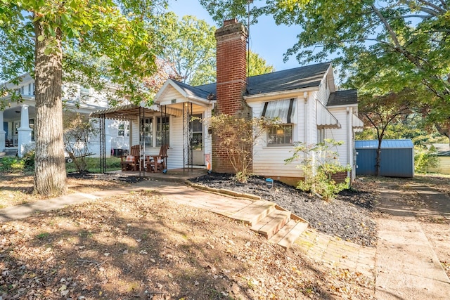 view of front facade with a shed and a porch