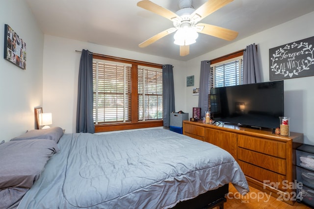 bedroom with hardwood / wood-style floors and ceiling fan