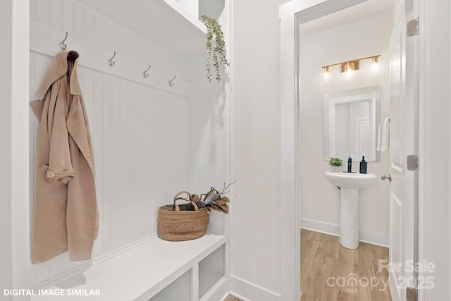 mudroom with light wood-type flooring and baseboards