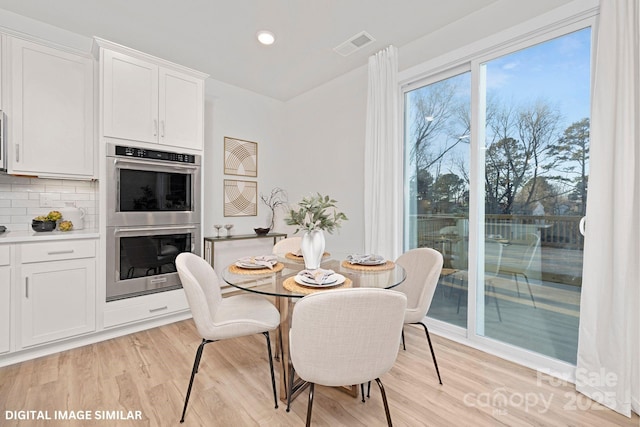 dining area featuring light wood-type flooring, visible vents, and recessed lighting