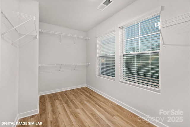 spacious closet with visible vents and wood finished floors