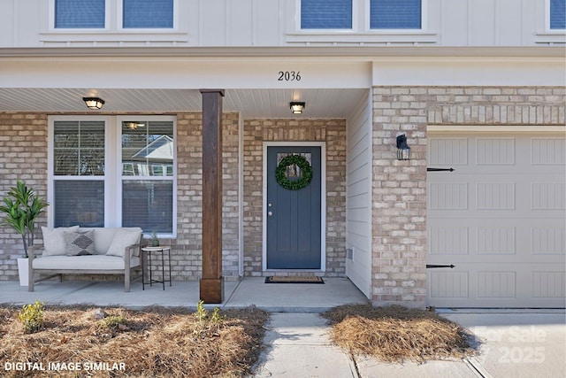 property entrance featuring covered porch and board and batten siding