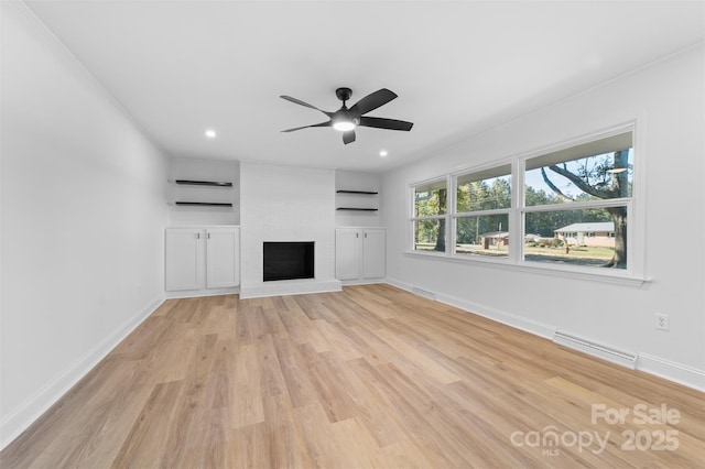 unfurnished living room featuring baseboards, light wood-style floors, visible vents, and a large fireplace