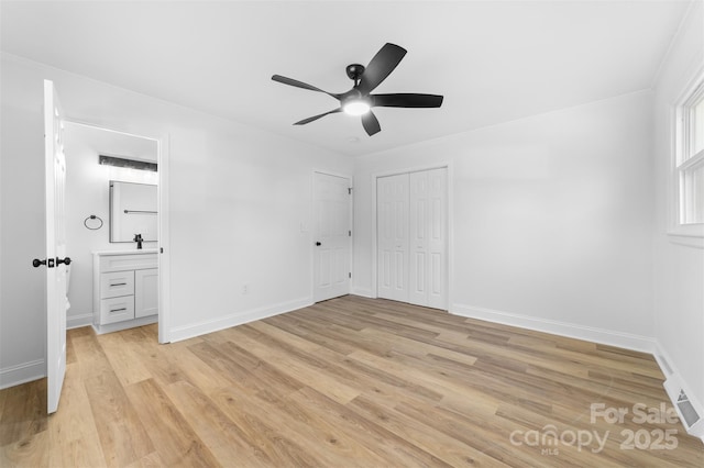 unfurnished bedroom featuring a ceiling fan, light wood-style floors, and baseboards