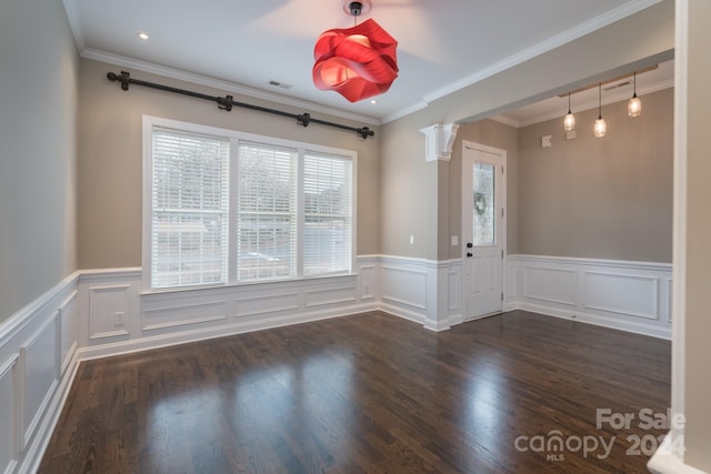 unfurnished room featuring dark hardwood / wood-style flooring, ornate columns, and crown molding