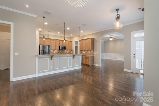 kitchen with pendant lighting, tasteful backsplash, stainless steel appliances, and dark hardwood / wood-style floors