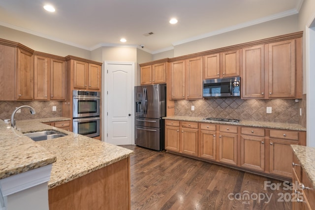 kitchen featuring sink, crown molding, stainless steel appliances, light stone counters, and dark hardwood / wood-style flooring