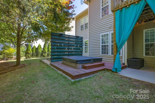 wooden terrace featuring a lawn