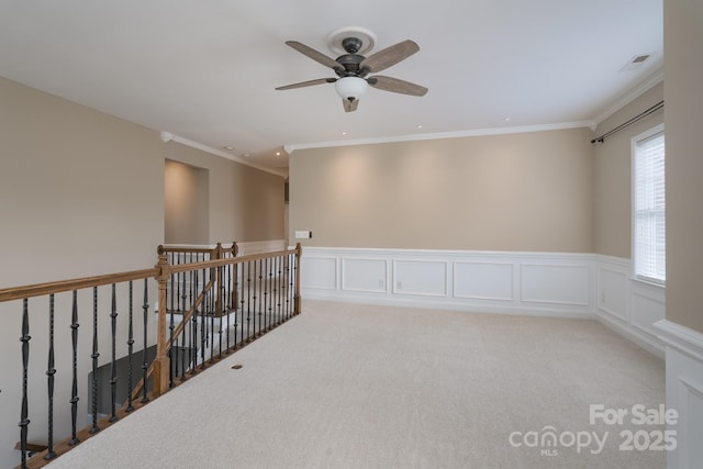 unfurnished room featuring ornamental molding and light carpet