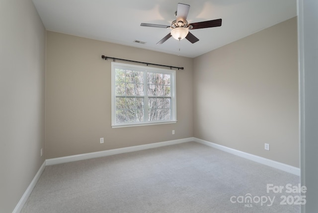 spare room with carpet floors and ceiling fan