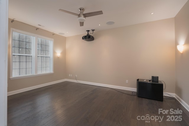 unfurnished room with dark hardwood / wood-style flooring and ceiling fan