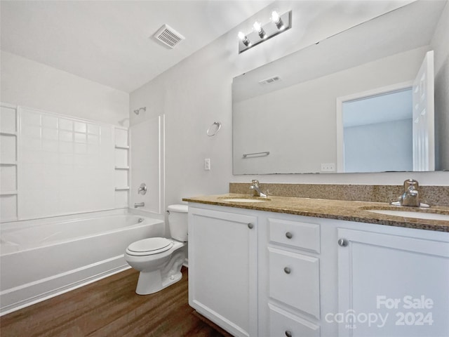 full bathroom featuring toilet, vanity, wood-type flooring, and shower / bathtub combination