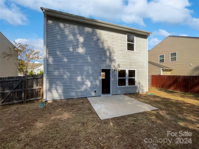 back of property with a patio