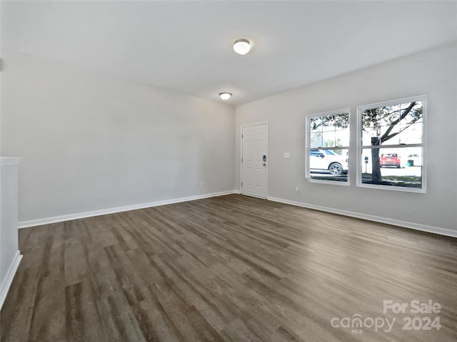 unfurnished room with dark hardwood / wood-style floors