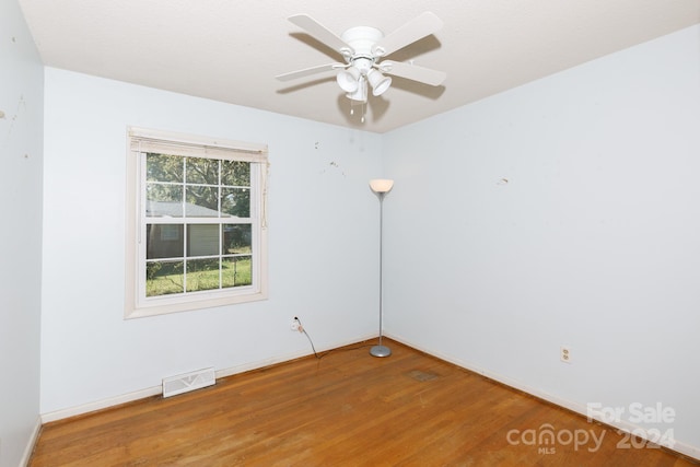 unfurnished room with ceiling fan and wood-type flooring