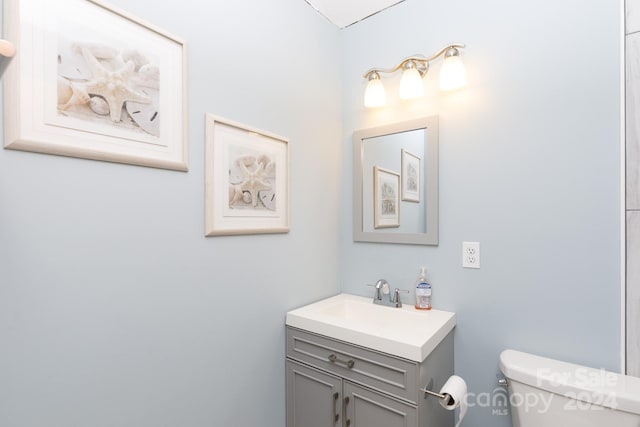 bathroom featuring toilet and vanity