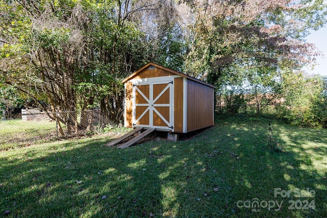 view of outbuilding with a lawn