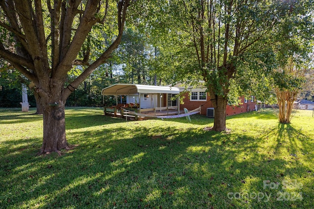 view of yard with a patio and central AC unit