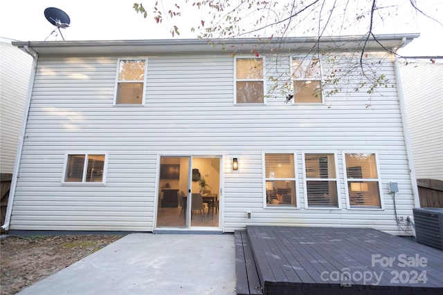 rear view of property with central AC, a wooden deck, and a patio area