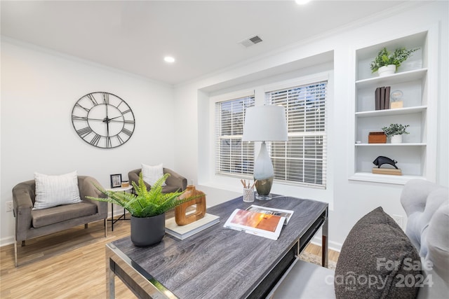 interior space featuring ornamental molding and light wood-type flooring