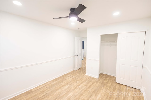 unfurnished bedroom featuring a closet, light wood-type flooring, and ceiling fan