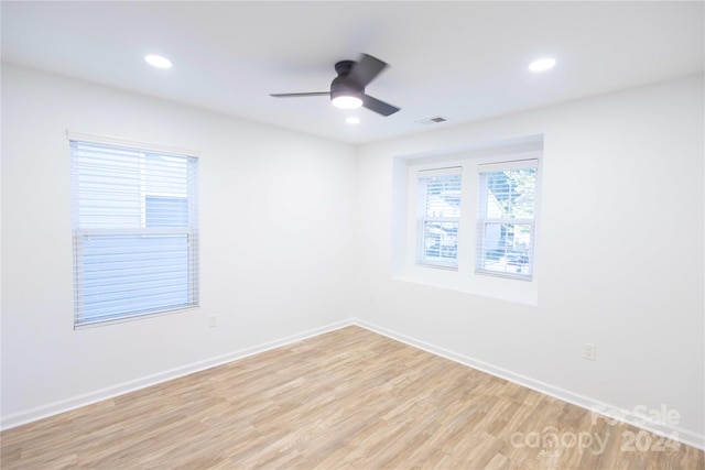 unfurnished room featuring light hardwood / wood-style flooring and ceiling fan