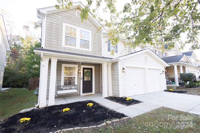 view of front of house featuring covered porch and a garage