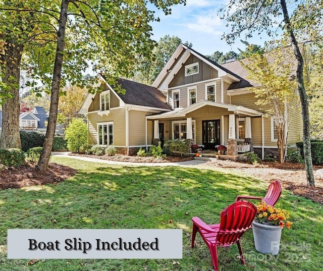 craftsman inspired home featuring covered porch and a front lawn