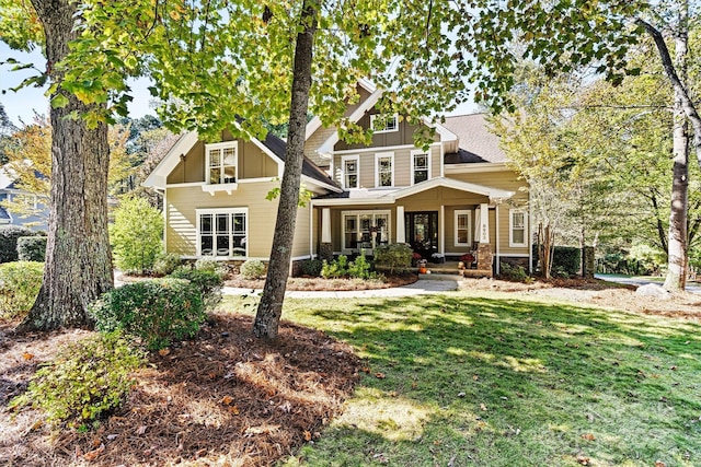 back of house with a lawn and a porch