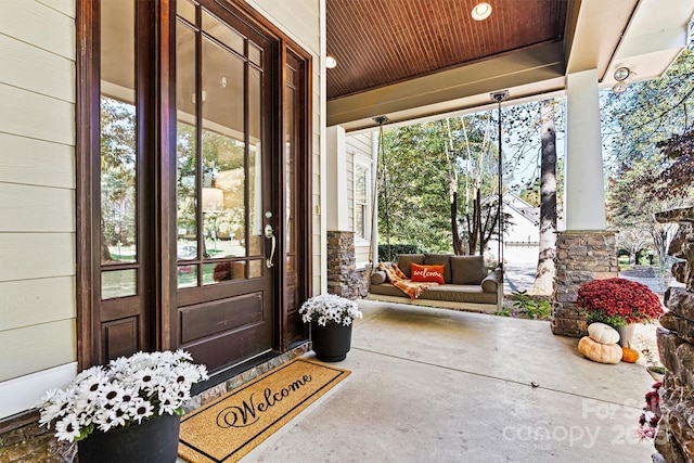 doorway to property featuring covered porch