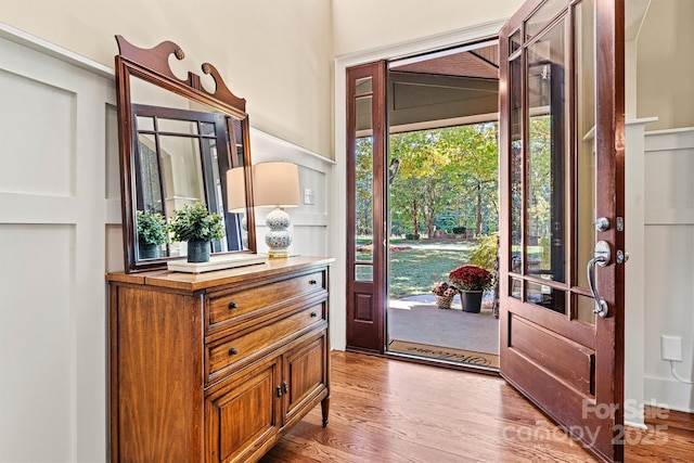 foyer entrance with hardwood / wood-style floors and a healthy amount of sunlight