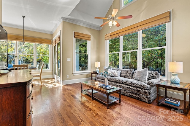 living room with ceiling fan, wood-type flooring, and ornamental molding