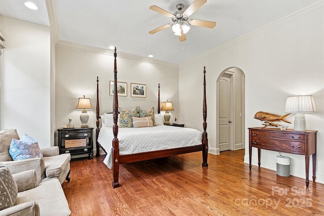 bedroom featuring hardwood / wood-style flooring, ceiling fan, and crown molding