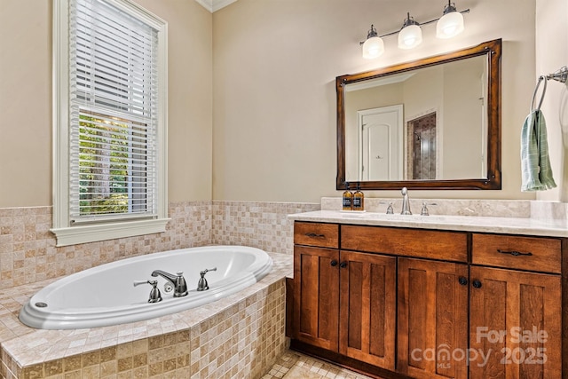 bathroom with tiled tub and vanity