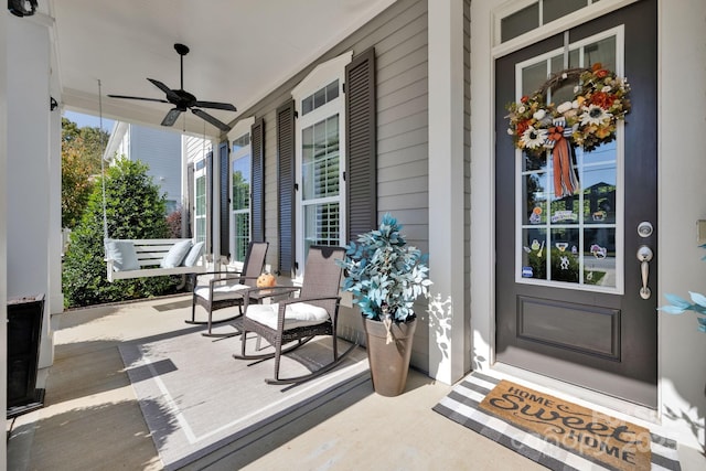 entrance to property with ceiling fan and covered porch