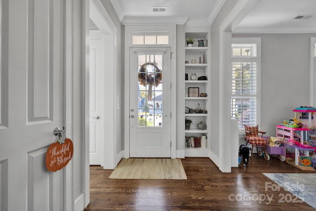 foyer entrance with ornamental molding and dark hardwood / wood-style floors