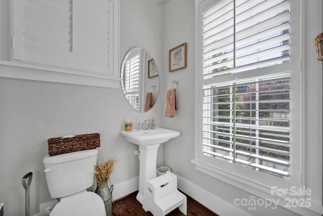 bathroom with plenty of natural light, sink, and toilet