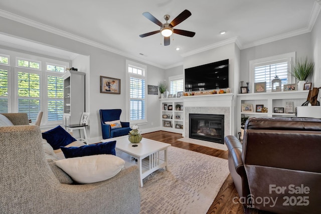 living room with ornamental molding, hardwood / wood-style floors, and a wealth of natural light