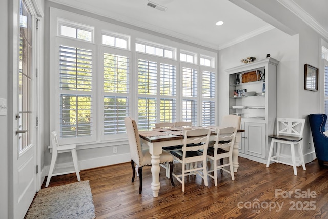 dining room featuring ornamental molding and dark hardwood / wood-style floors