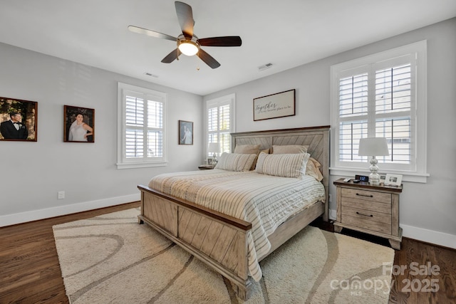 bedroom with dark hardwood / wood-style flooring and ceiling fan