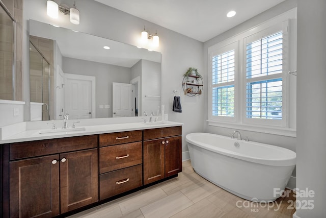 bathroom featuring vanity and separate shower and tub