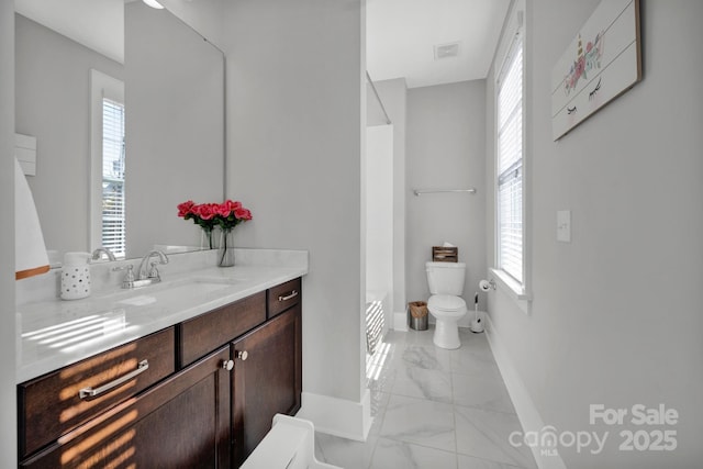 bathroom featuring vanity and toilet