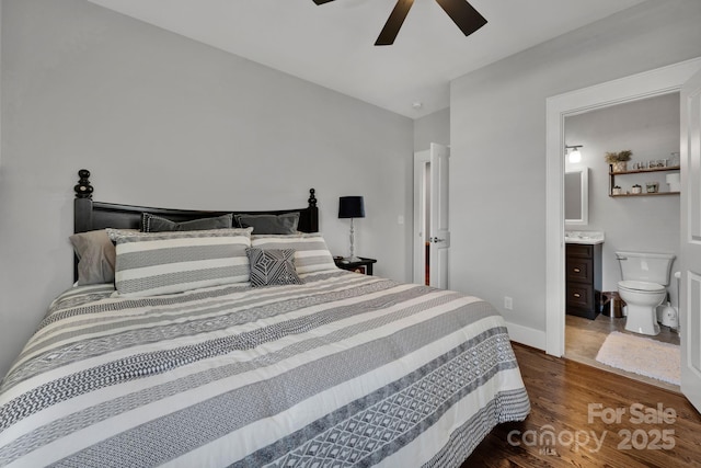 bedroom featuring dark hardwood / wood-style flooring, connected bathroom, and ceiling fan