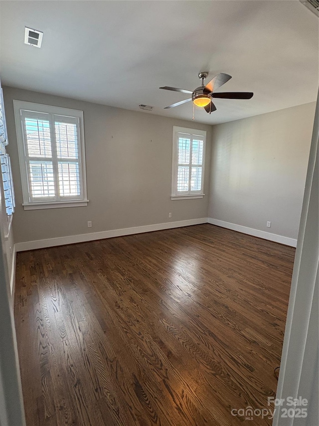 unfurnished room with ceiling fan and dark hardwood / wood-style flooring